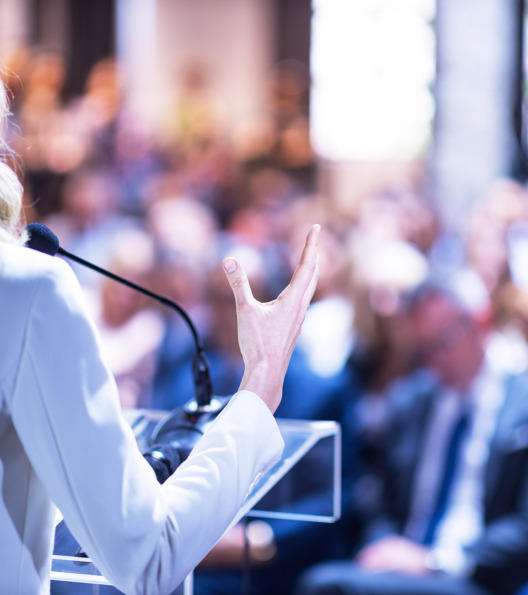 Female speaker at business conference, corporate presentation, workshop, coaching training, news conference, company meeting, public or political event. Public speaking concept.